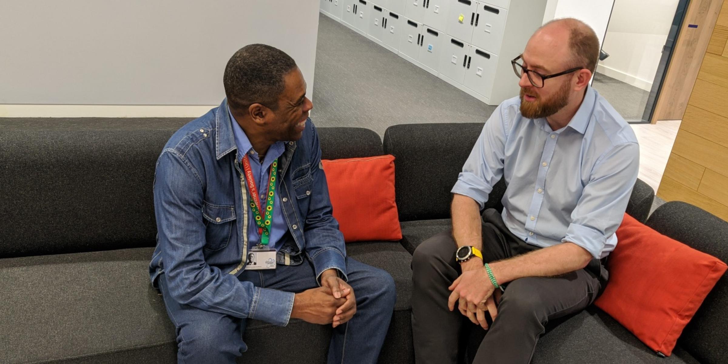 A person wearing his sunflower lanyard and chatting