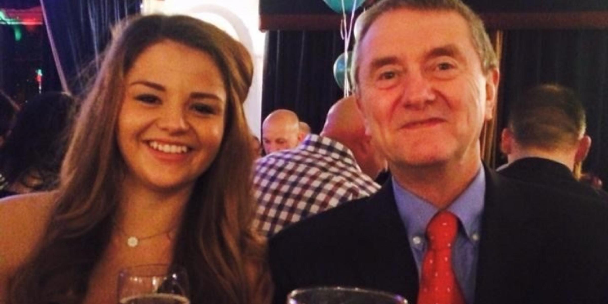 Jess smiling beside her dad at a special event