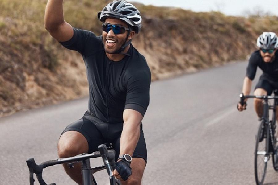Two cyclists on an open road.