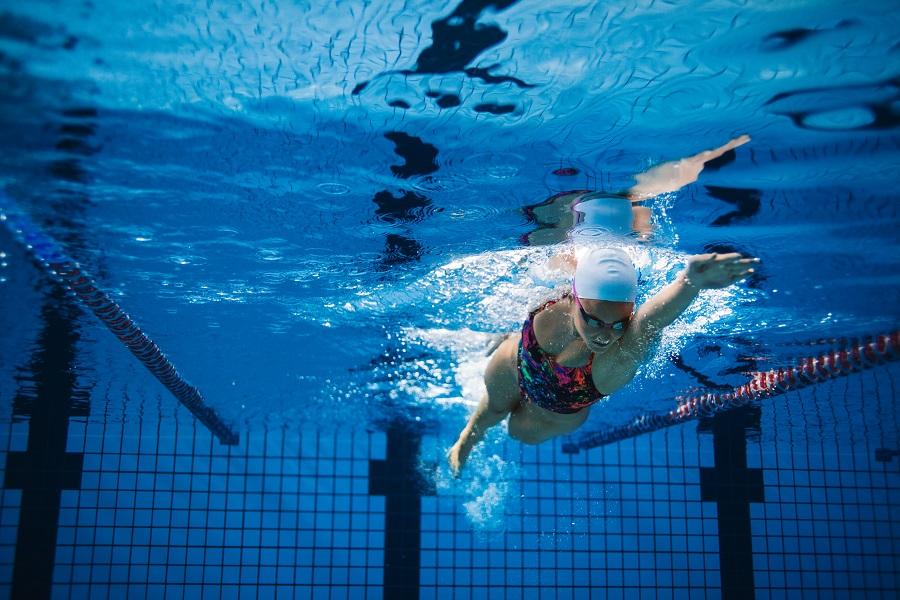 Lady swimming front crawl in a pool