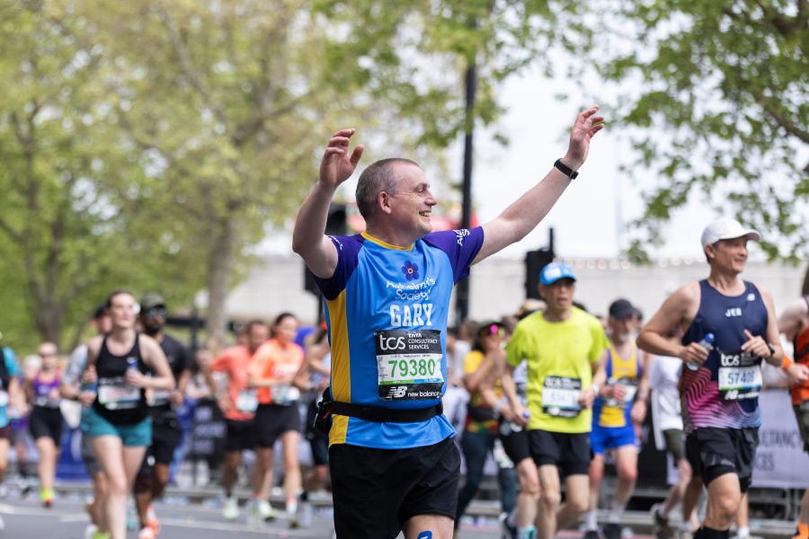 Man running with hands in the air