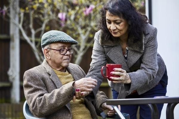 Supporting a dementia patient with a cup of tea