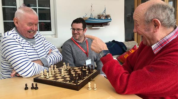 Ian and Raymond play chess.