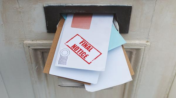 Uncollected post in a letterbox
