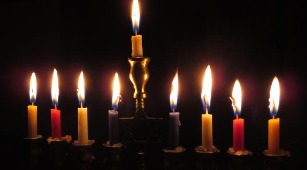Nine lit menorah candles for a dementia-friendly Hanukkah