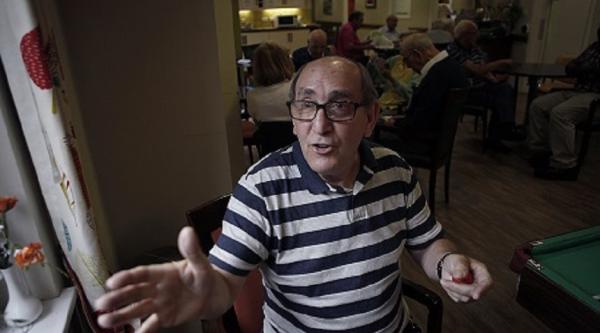 A man, Hymie Gold, gesturing while talking