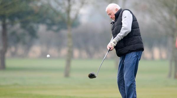 A member of Golf in Society taking a shot