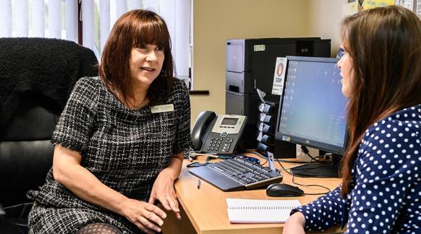 A GP chats to an Alzheimer's Society staff member
