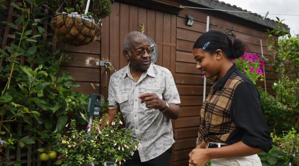 Raymond James in the garden with his grandaughter