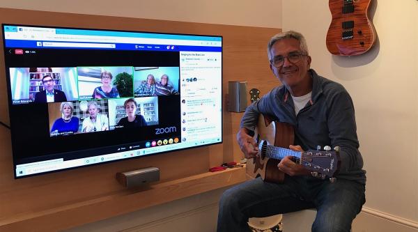 Martyn plays guitar along to Singing for the Brain Live