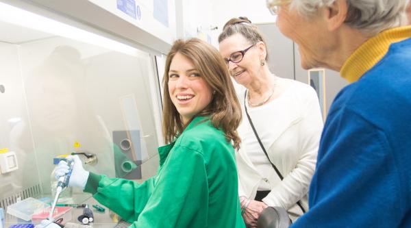 Researcher in the lab looking over her shoulder and smiling