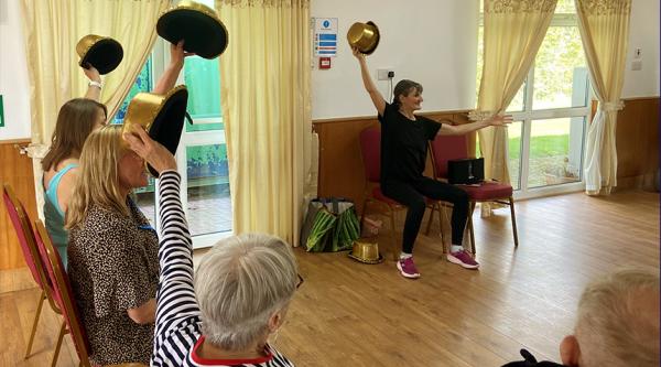 People holding hats in the air at a group activity