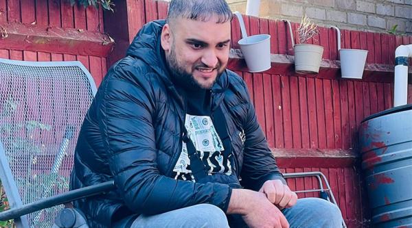 Uamar Khan sitting outside.