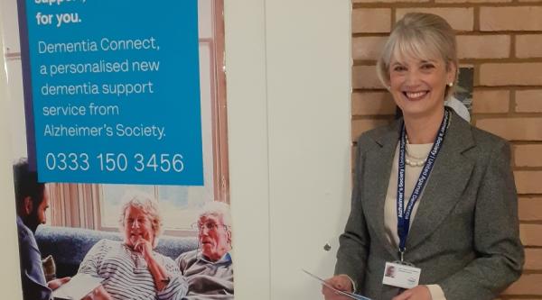 Hazel at a dementia information booth, handing out leaflets