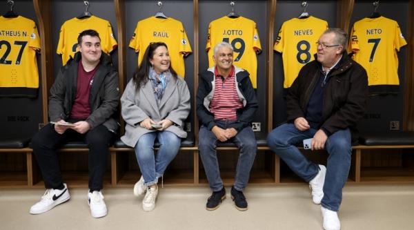 Four people sat smiling in the Wolverhampton Wanderers dressing room