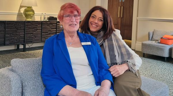Joy Watson (left) sits with Kate Lee on a sofa