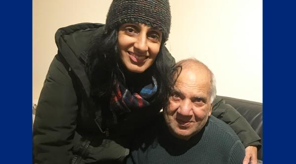 Kash and her father-in-law Dave sit on a sofa together and hug, smiling at the camera