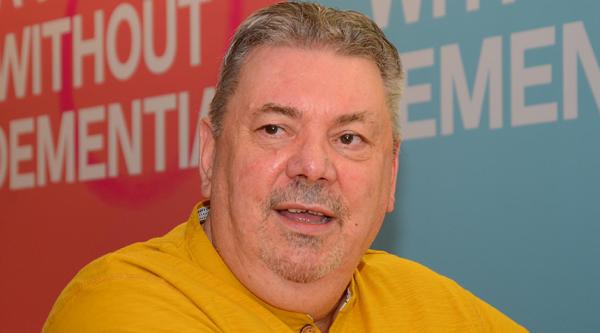 Nigel Hullah wears a yellow t-shirt