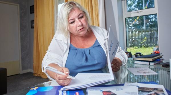 woman sat at the table looking at pamphlets