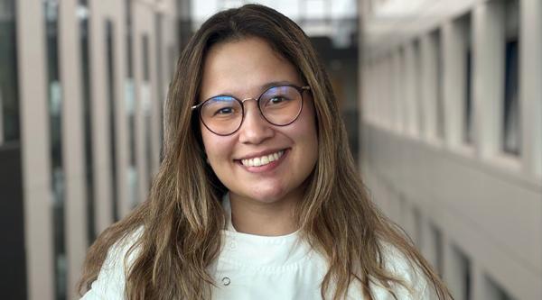 Melissa Parra Torres smiling and stood inside university building