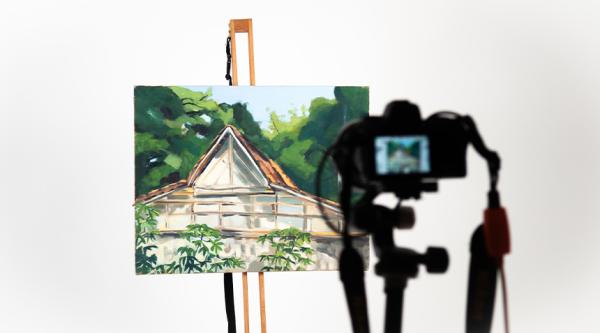 Painting being photographed on an easel