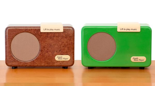 Simple music players in walnut burr and green sat on table