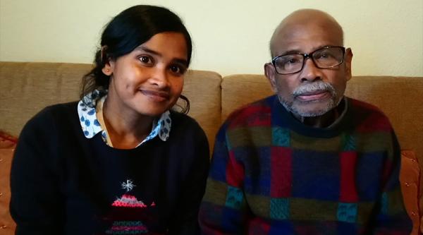 Dipali and her late father sat on a sofa