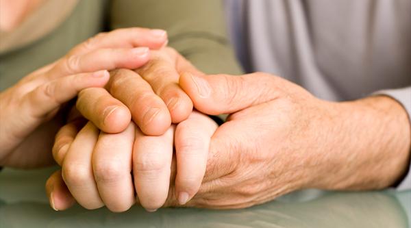 Hands being held in reassurance