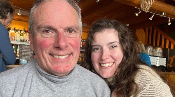 Lauren Hughes sits next to her dad, Chris, at a venue