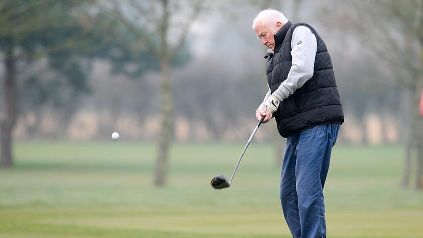 A Golf in Society member taking a shot.