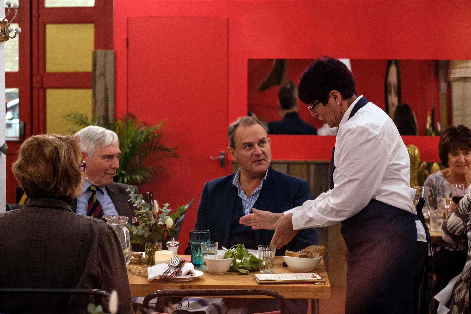Joy serving Hugh Bonneville at the restauraunt
