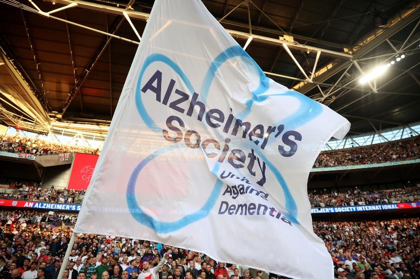 A flag with the Alzheimer's Society logo being waved in Wembley stadium