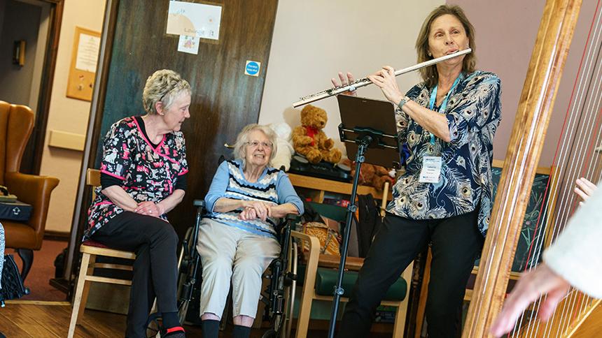 Catherine Handley plays the flute in a care home