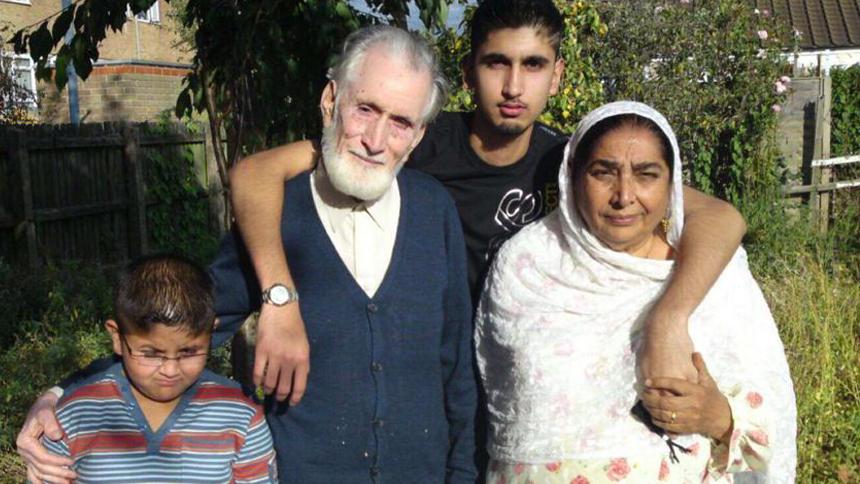 Matt's son with his arms around his grandparents with his younger brother.