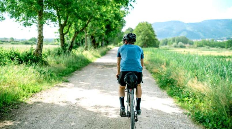 man on bike cycling country lane