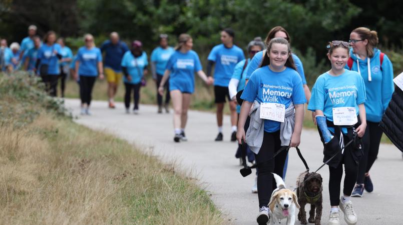 Memory Walkers coming around the corner in Sutton Park with their dogs
