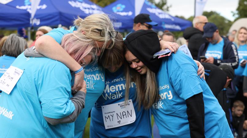 A group of Memory Walkers having a hug on the event site