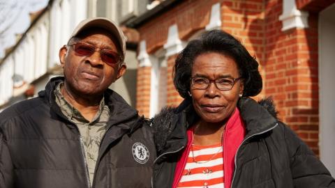Two people standing in the street, looking confidently at the camera