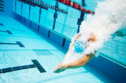 Swimmer diving into swimming pool