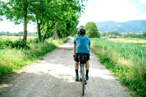 man on bike cycling country lane
