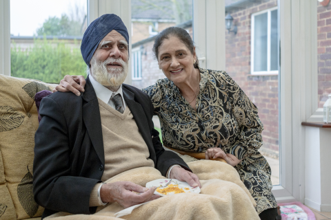 A couple sitting and smiling