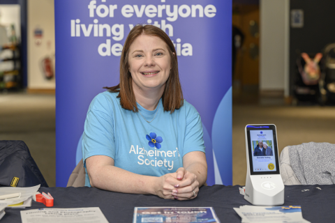 A supporter at a desk in an Alzheimer's Society t-shirt