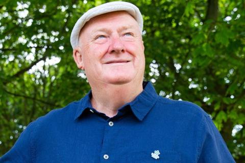 A Dementia Friends ambassador wearing a Dementia Friends badge