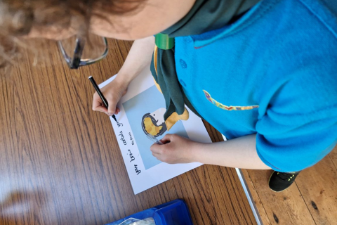 A young Dementia Friend taking part in a written activity