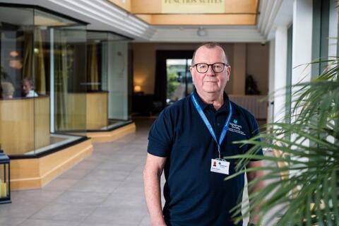 An Alzheimer's Society Dementia Adviser standing in a corridor