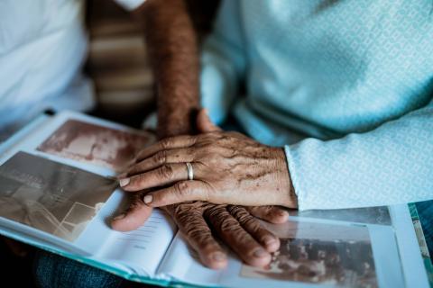 Two hands above an open photo album.